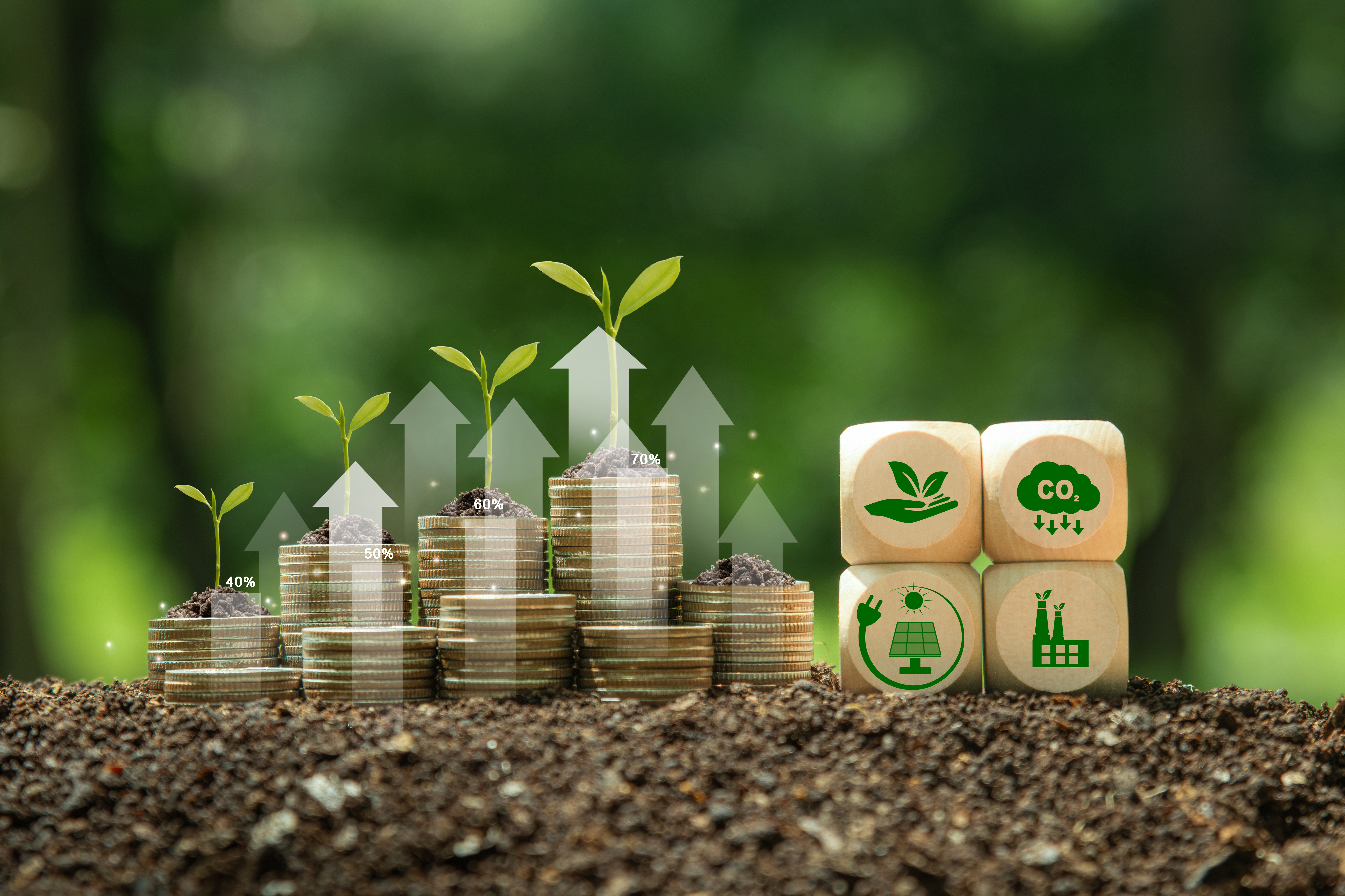 Stack of silver coins the seedlings are growing on top with arrow of growth and green business icons on wooden cube. Concept of Green business, finance and sustainability investment. Carbon credit.